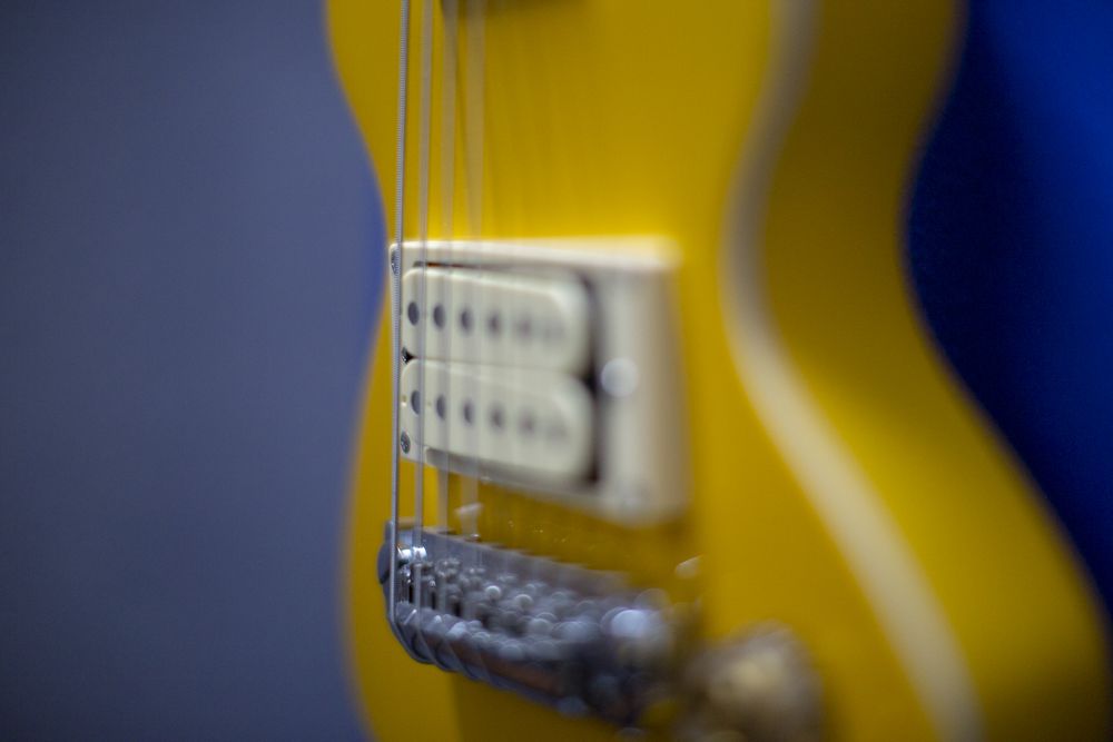 Close-up of a yellow electric guitar