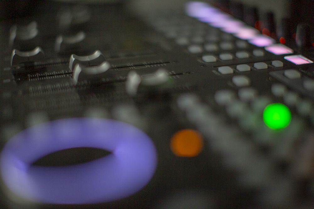 Mixing desk faders and lit buttons